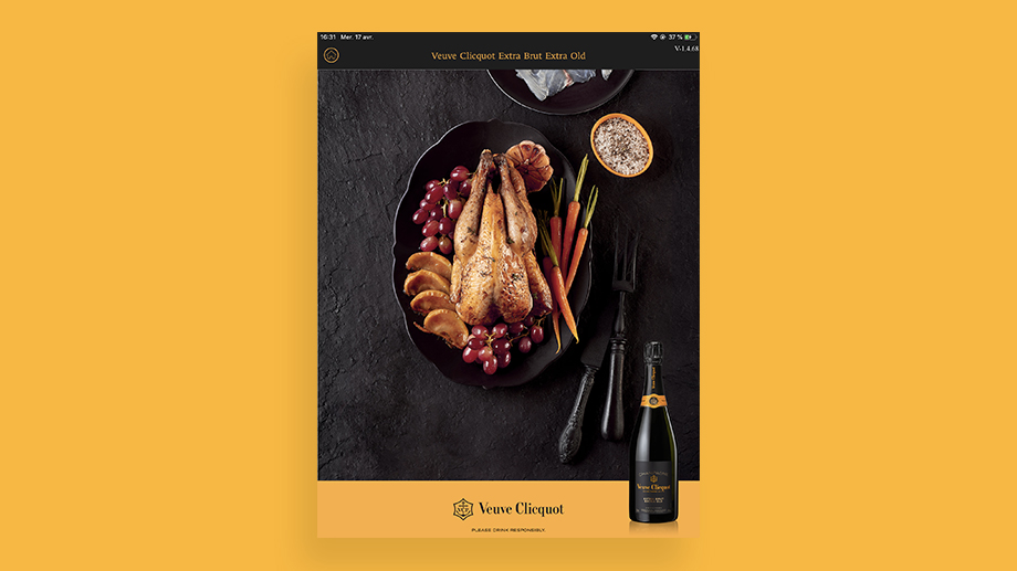 Ecran de l'application Veuve Clicquot sur la page du champagne extra brut extra old. Fond jaune avec une image de poulet rôti